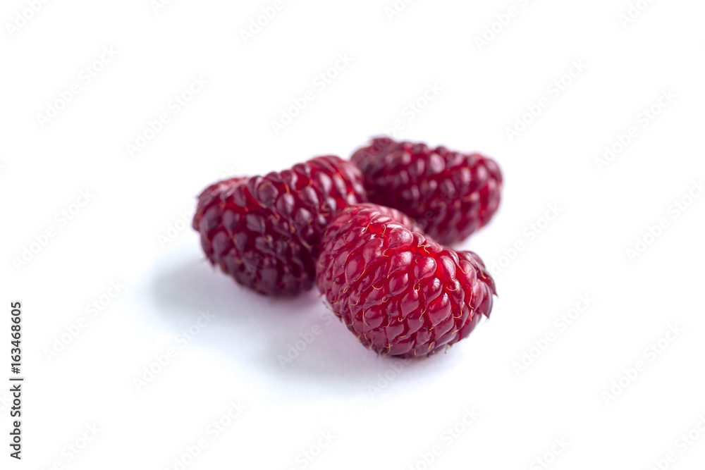 Heap of ripe wild raspberry isolated on a white Heap of ripe wild raspberry isolated on a white
