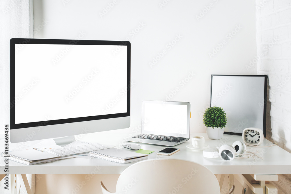 White designer desktop with computer and laptop White designer desktop with computer and laptop