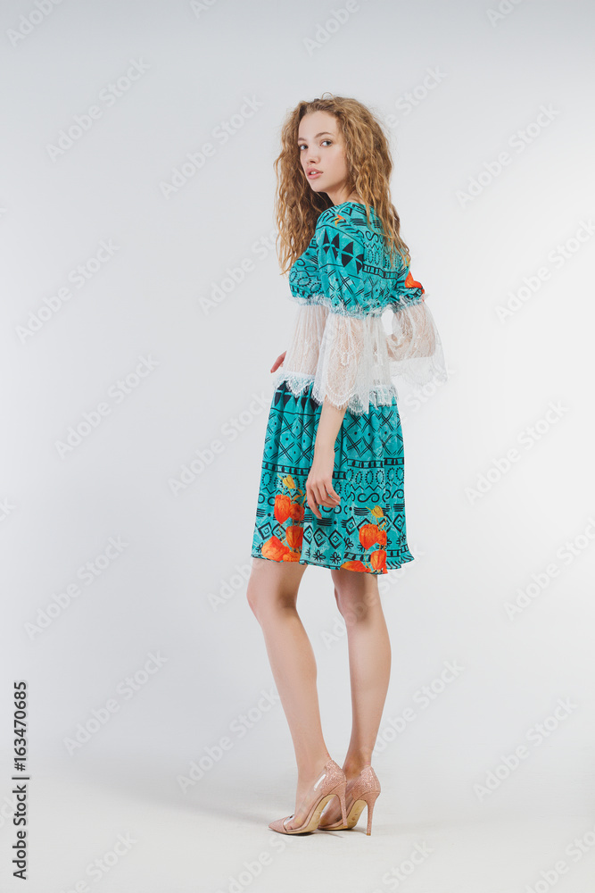 Beautiful girl in studio in fashion clothes on a white background Beautiful girl in studio in fashion clothes on a white background