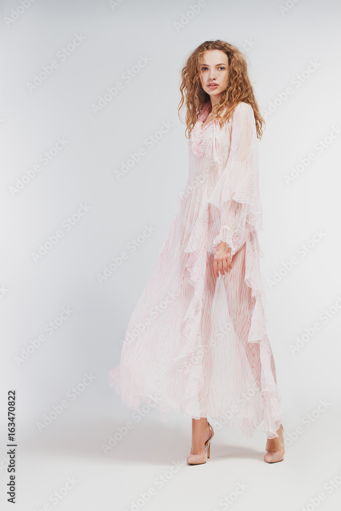 Beautiful girl in studio in fashion clothes on a white background Beautiful girl in studio in fashion clothes on a white background