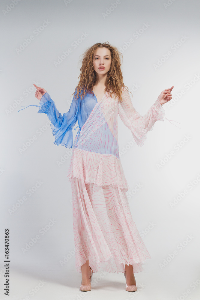 Beautiful girl in studio in fashion clothes on a white background Beautiful girl in studio in fashion clothes on a white background