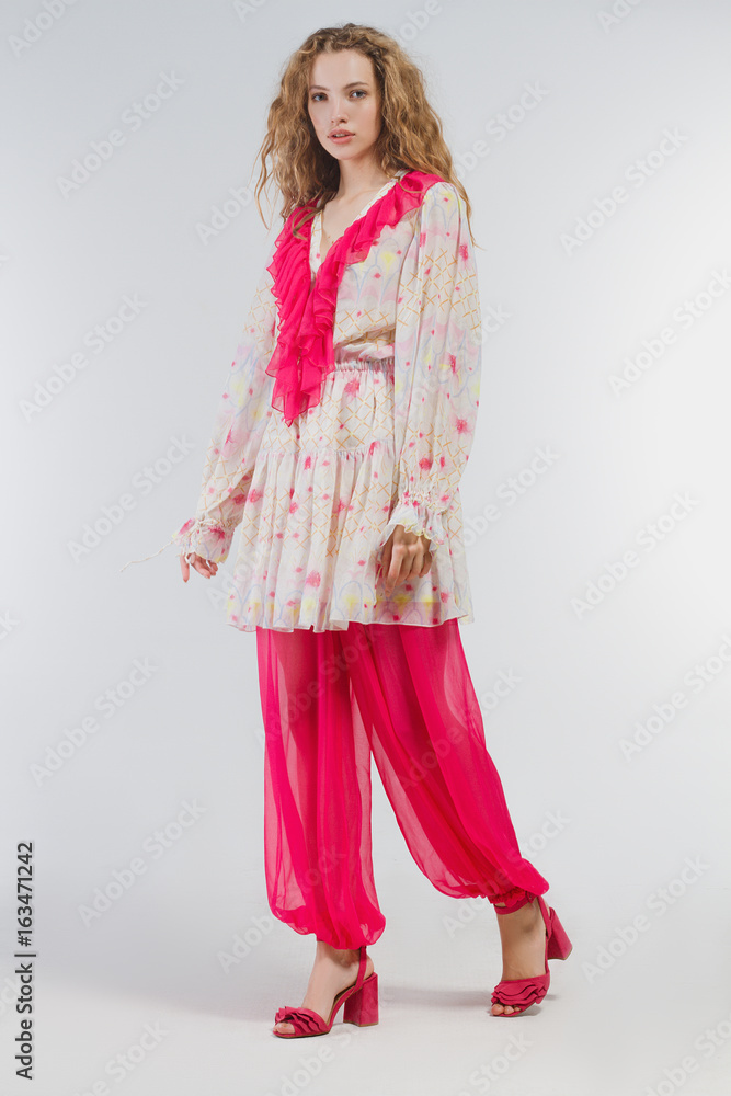 Beautiful girl in studio in fashion clothes on a white background Beautiful girl in studio in fashion clothes on a white background