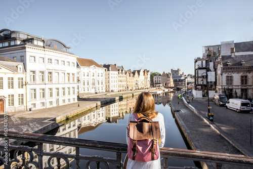 Woman enjoying great view on the water channel standing back on the bridge in Gent city in Belgium © rh2010