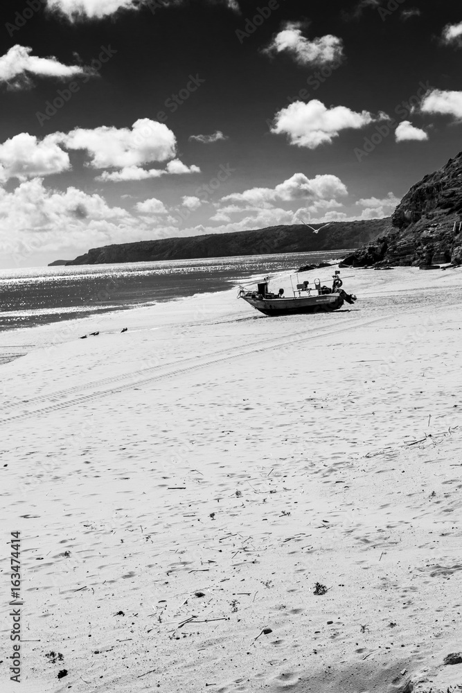 Stranded boat in the beach of Salema (Algarve, Portugal) Stranded boat in the beach of Salema (Algarve, Portugal)