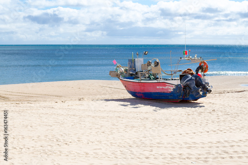 Stranded boat in the beach of Salema (Algarve, Portugal) © rmbarricarte