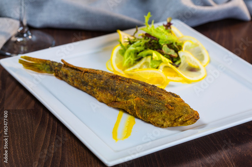 Tableau sur toile Fried fish. Fish steers. Fish fried in flour with garnish