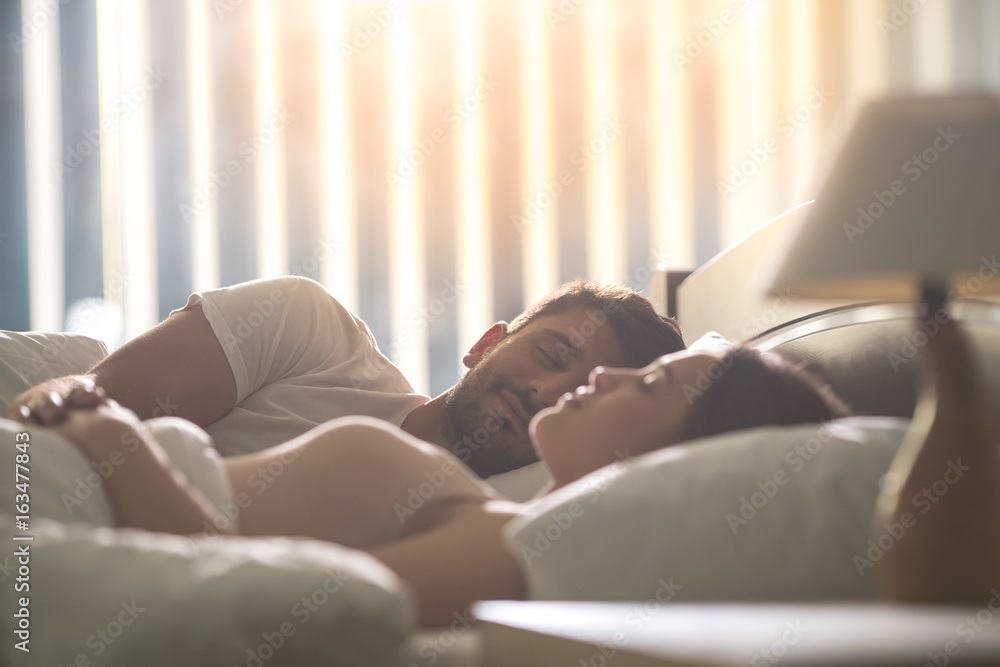 The man sleeping near a woman in the comfortable bed The man sleeping near a woman in the comfortable bed