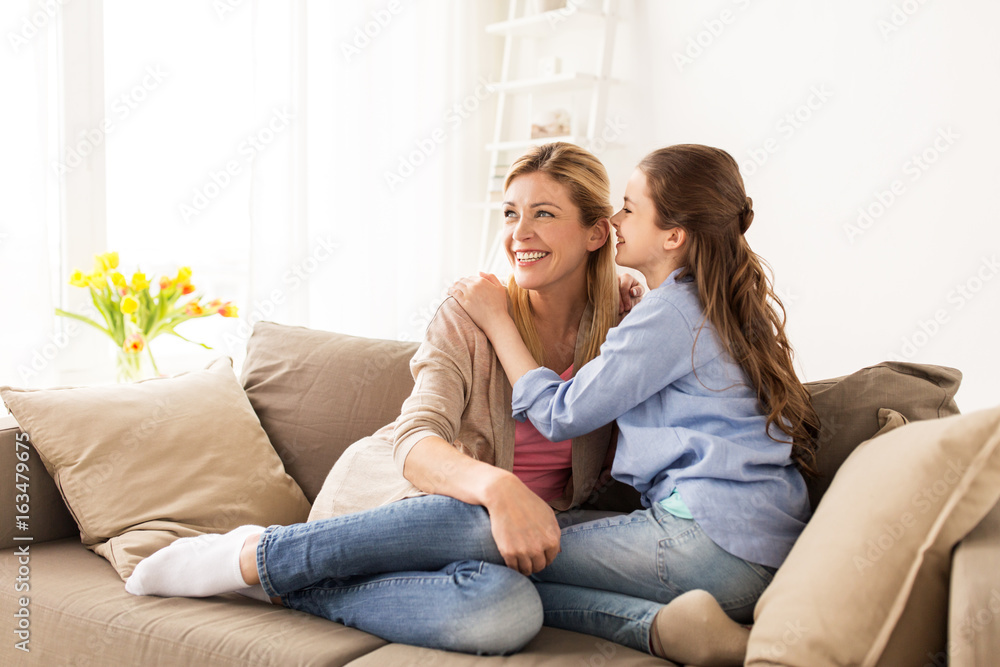 happy girl whispering secret to her mother at home happy girl whispering secret to her mother at home