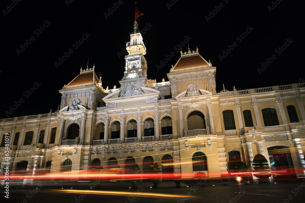 Ho Chi Minh City, Vietnam - July 7, 2017: Long exposure traffic light trails in front of Ho Chi Minh City Hall or Saigon City Hall.