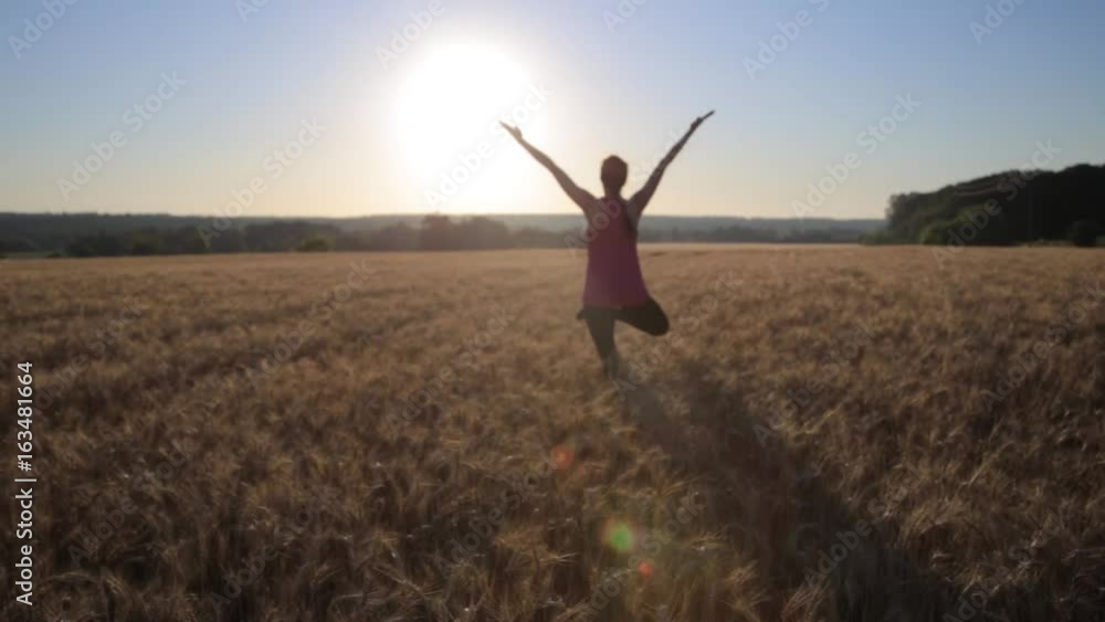 Woman doing yoga exercising healthy lifestyle fitness outdoor in the field at sunrise. Woman doing yoga exercising healthy lifestyle fitness outdoor in the field at sunrise.