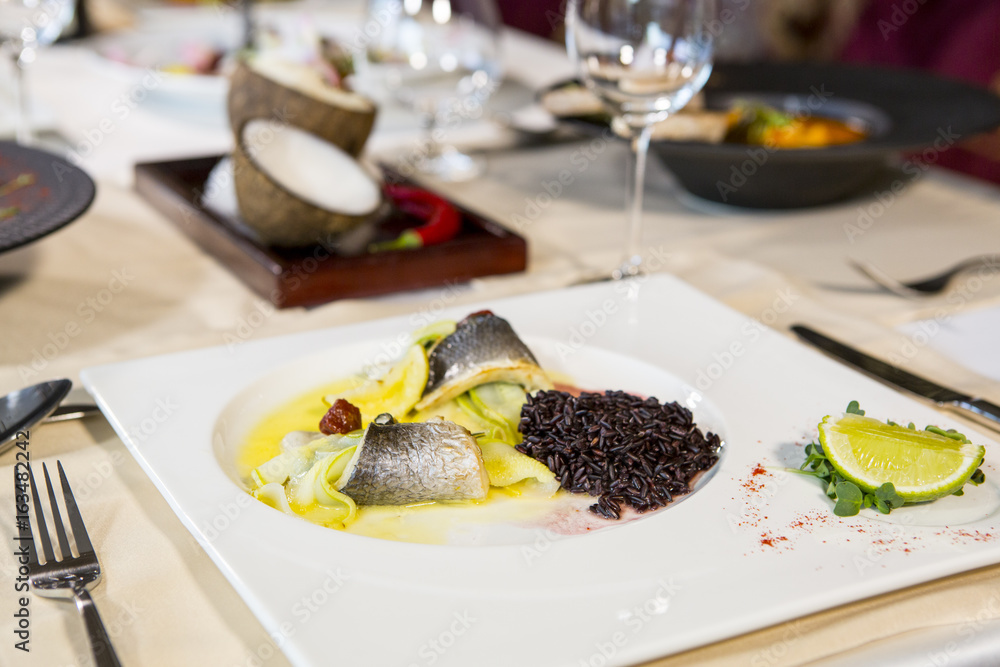 Baked fillet of Dorado fish with garnish of red rice Baked fillet of Dorado fish with garnish of red rice