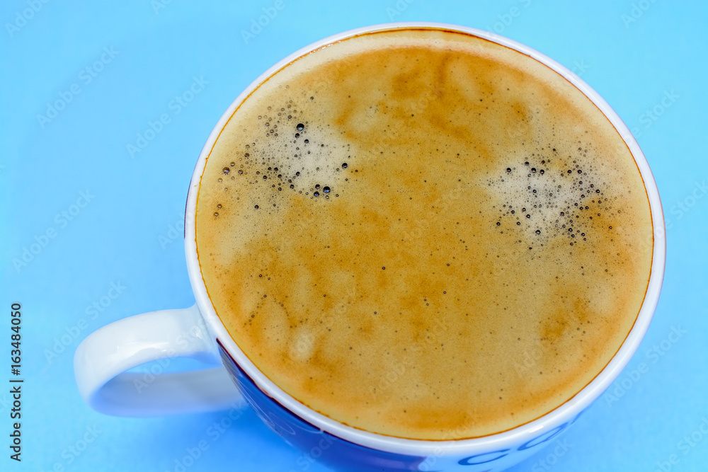 A cup of coffee on a blue background