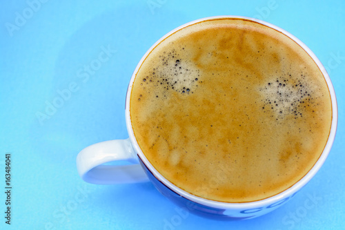A cup of coffee on a blue background