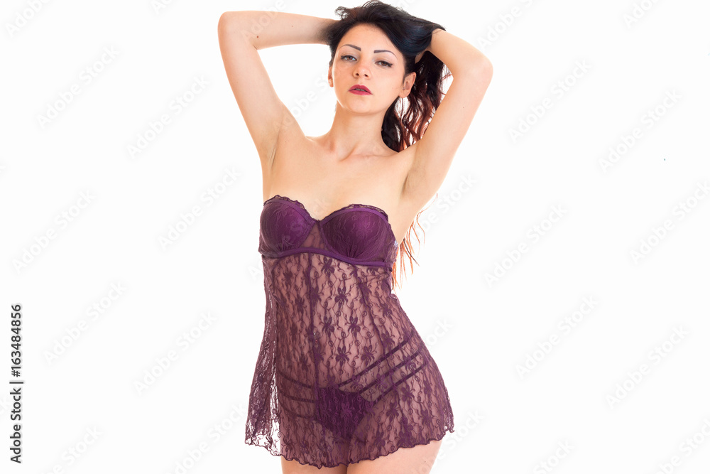 beautiful young women in soft negligee keeps hands hair and looks into a camera beautiful young women in soft negligee keeps hands hair and looks into a camera