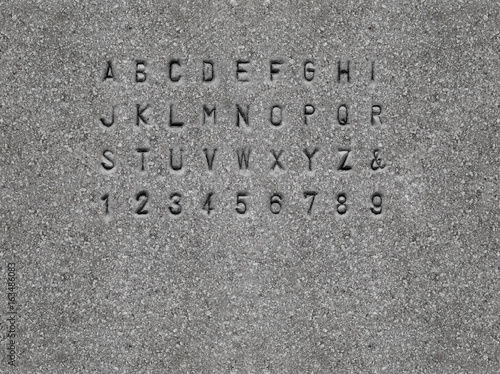 Sans-serif font chiseled on granite stone