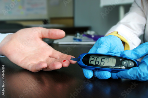 Female doctor showing very bad blood sugar level test results. Health care concept