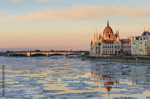 Scenic winter view of the embankment of the Danube and the Hungarian Parliament building in the soft evening light, Budapest, Hungary