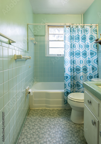 Simple dated 1950s bathroom with green tile.