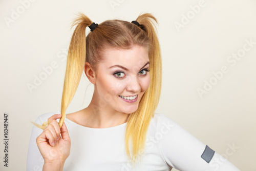 Happy blonde teenager girl with ponytails