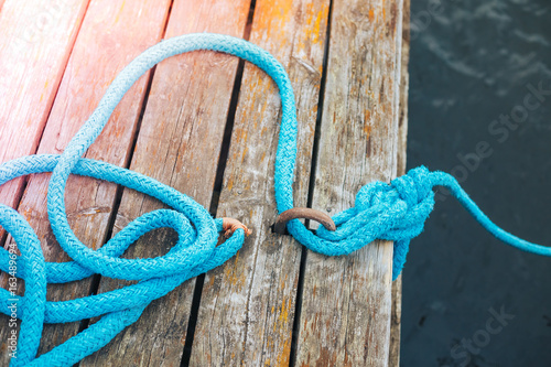 Marine rope on wooden background photo