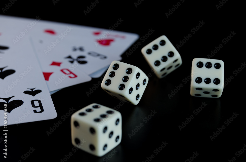 Dice, playing cards on a black background Dice, playing cards on a black background