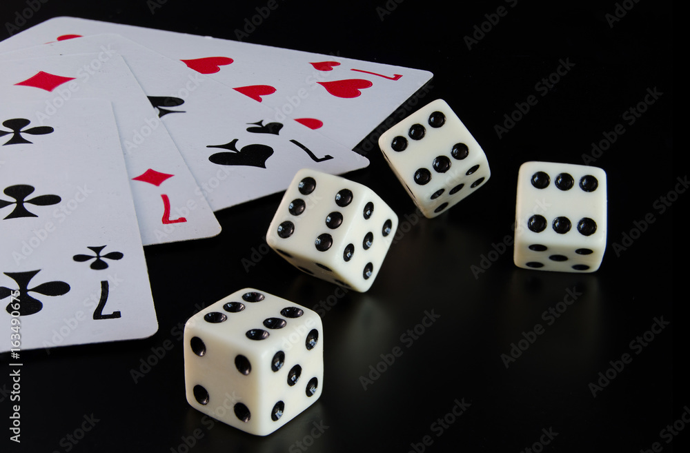 Dice, playing cards on a black background Dice, playing cards on a black background