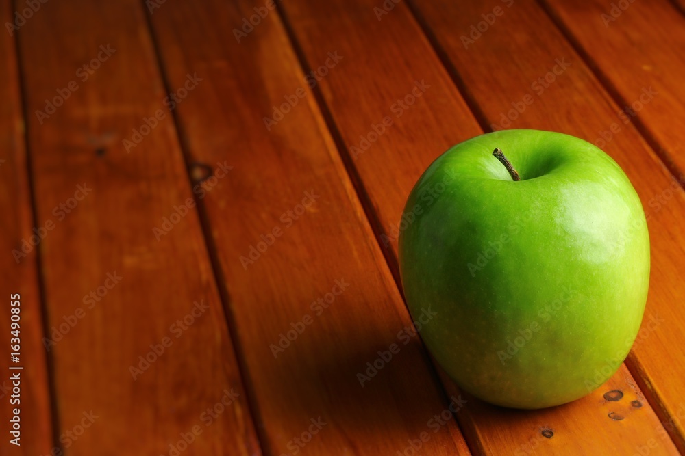 green apple on wood rustic table green apple on wood rustic table