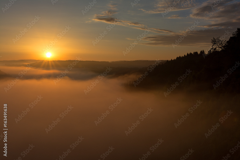 Belgian countryside - Ardennes. View over the Semois valley covered by clouds in the Belgian Ardennes in the early morning.
