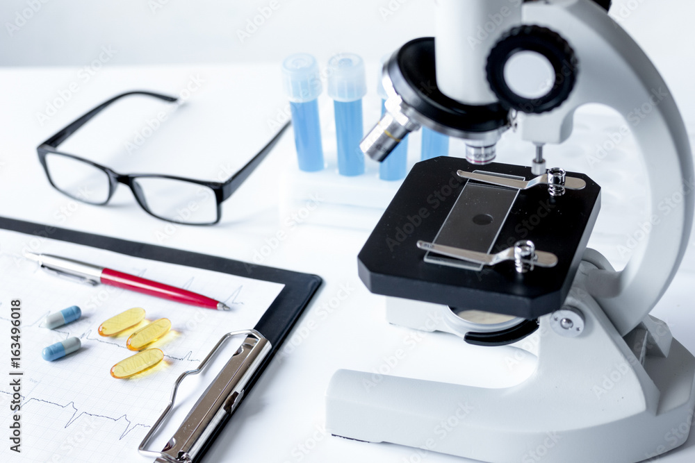 doctors desk with microscope and test tubes doctors desk with microscope and test tubes