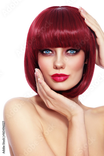 Beautiful fashion redhead girl with bob haircut and stylish make-up over white background, copy space