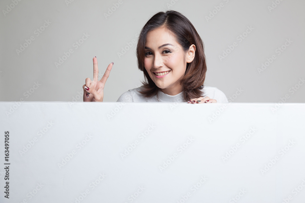 Young Asian woman show victory sign with blank sign. Young Asian woman show victory sign with blank sign.
