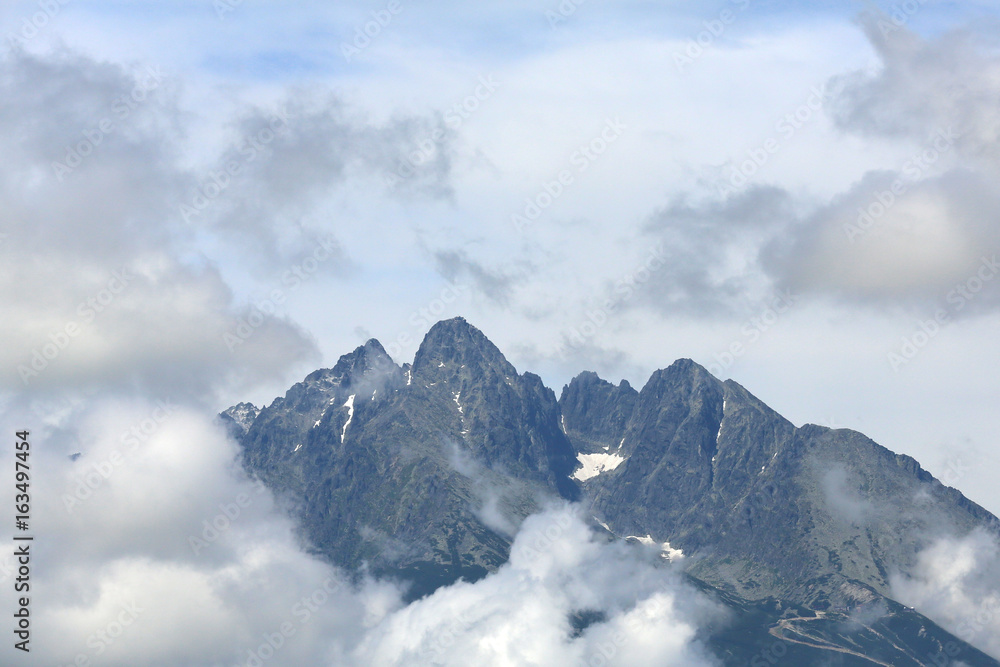 The tops of the mountains in the clouds