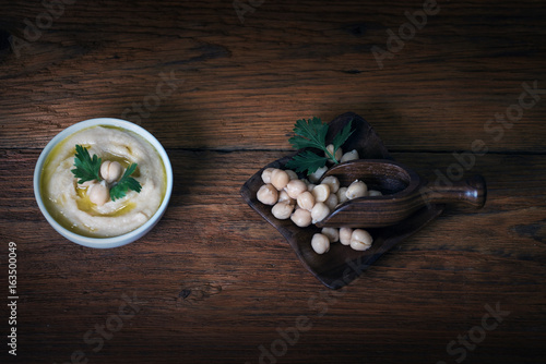 Hummus on a rustic wooden table