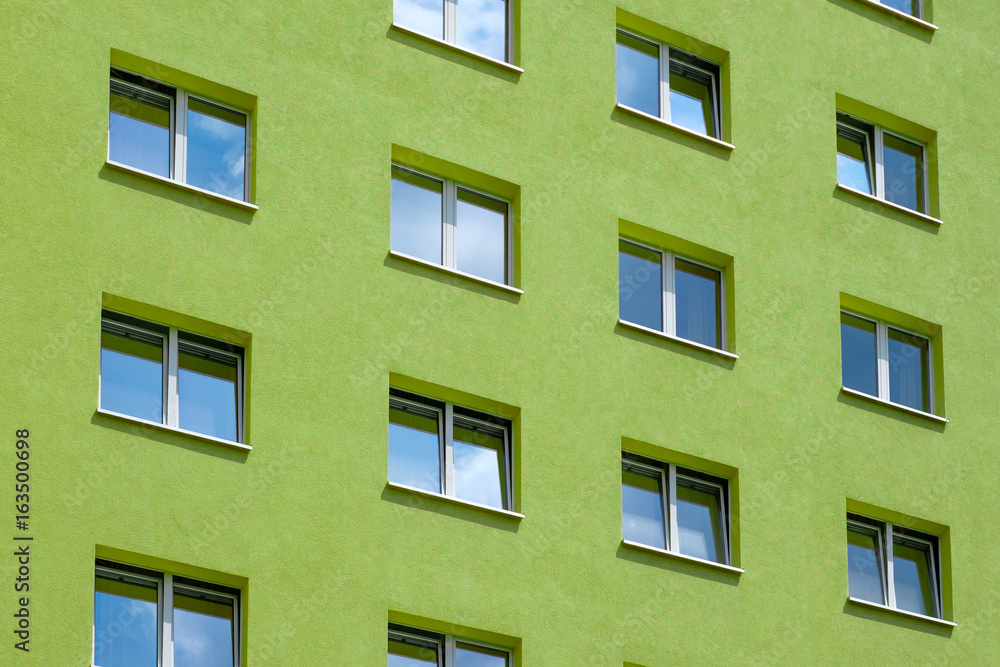 green building exterior , windows on house facade