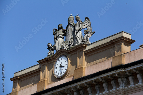 Piacenza; orologio e statue a coronamento del vescovado photo