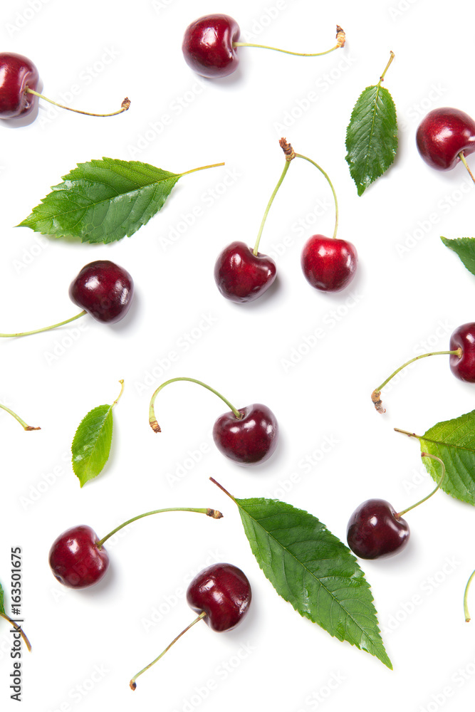 Ripe cherry berries and cherry leaves pattern isolated on white background, top view Ripe cherry berries and cherry leaves pattern isolated on white background, top view
