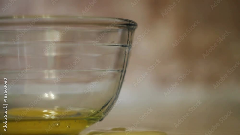 Cooking food. Fresh organic eggs falling into bowl. Food ingredient. Egg yolk falling in glass bowl. Baking ingredients, separating the yolk from the protein. Preparing ingredients for baking cake Cooking food. Fresh organic eggs falling into bowl. Food ingredient. Egg yolk falling in glass bowl. Baking ingredients, separating the yolk from the protein. Preparing ingredients for baking cake