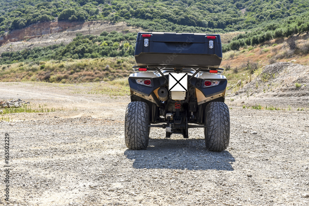 ATV offroad on mountain and sky background. ATV offroad on mountain and sky background.