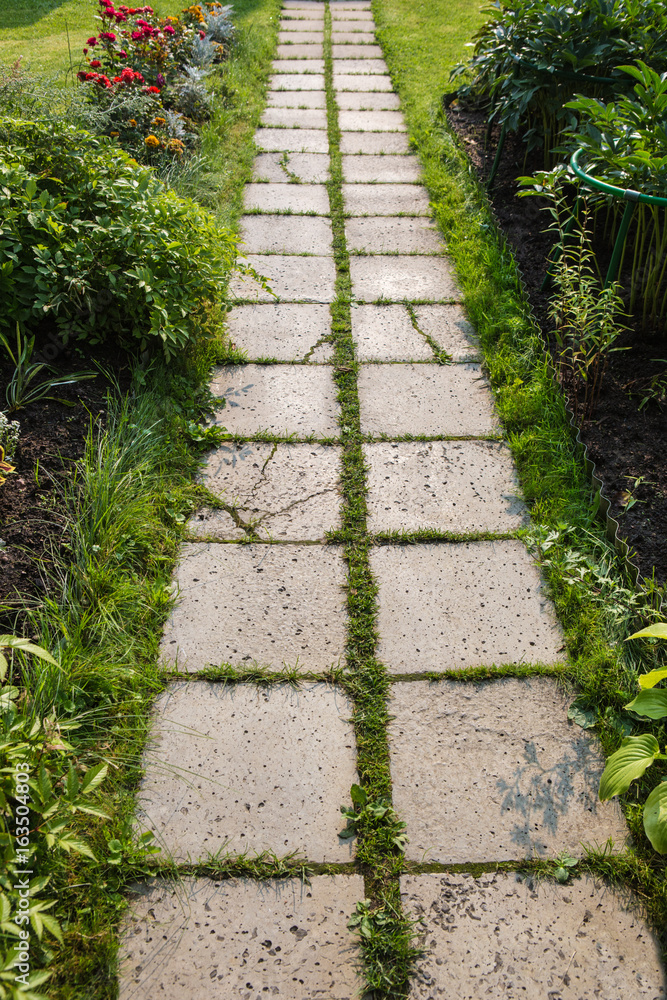 path of concrete tiles in garden
