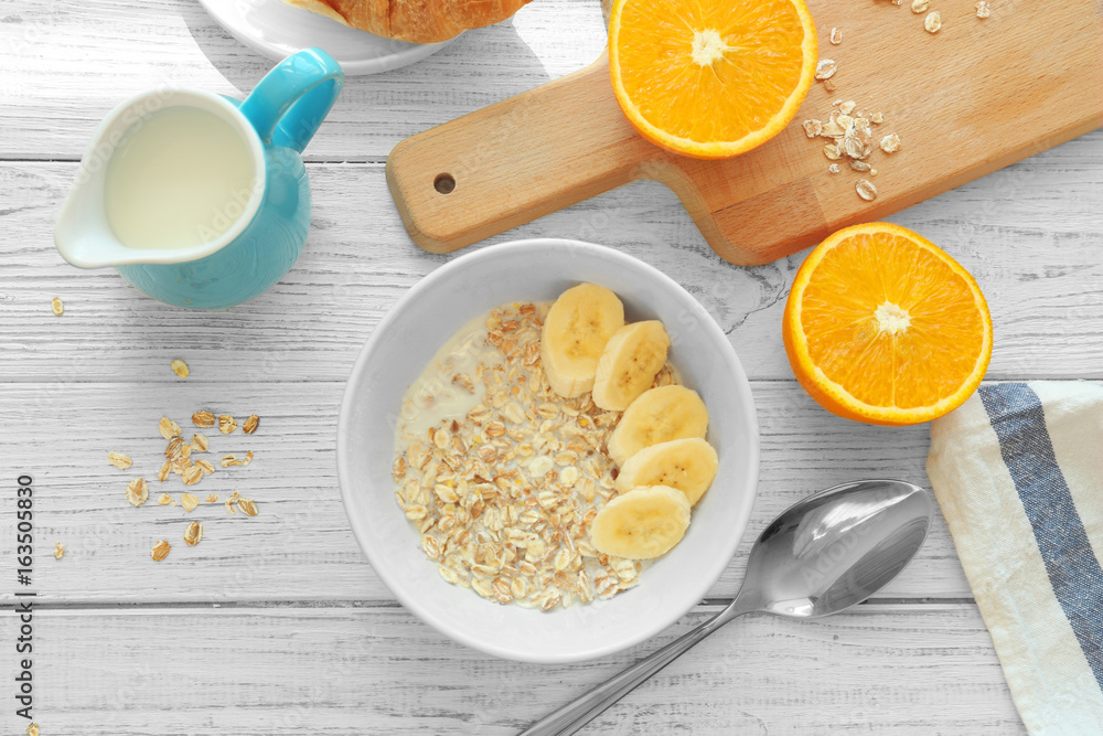 Nutritious oatmeal for breakfast served on wooden table Nutritious oatmeal for breakfast served on wooden table