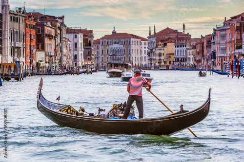 Men In Gondola On Canal In City, Venice, Italy
