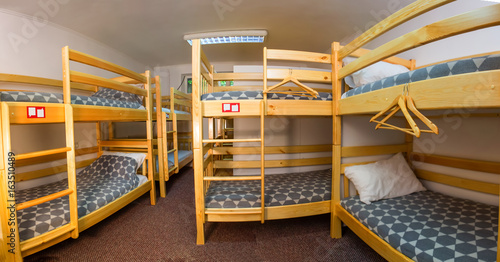 Tableau sur toile Interior of the hostel bedroom. Hostel with wooden bunk beds