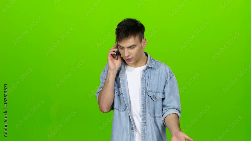 Man dials a familiar number and starts talking. Green screen Man dials a familiar number and starts talking. Green screen