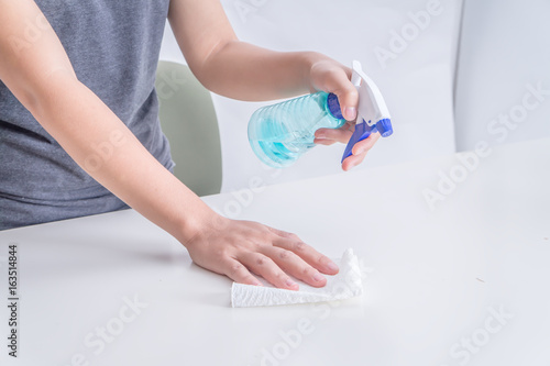 Housewives clean the desk in the office.