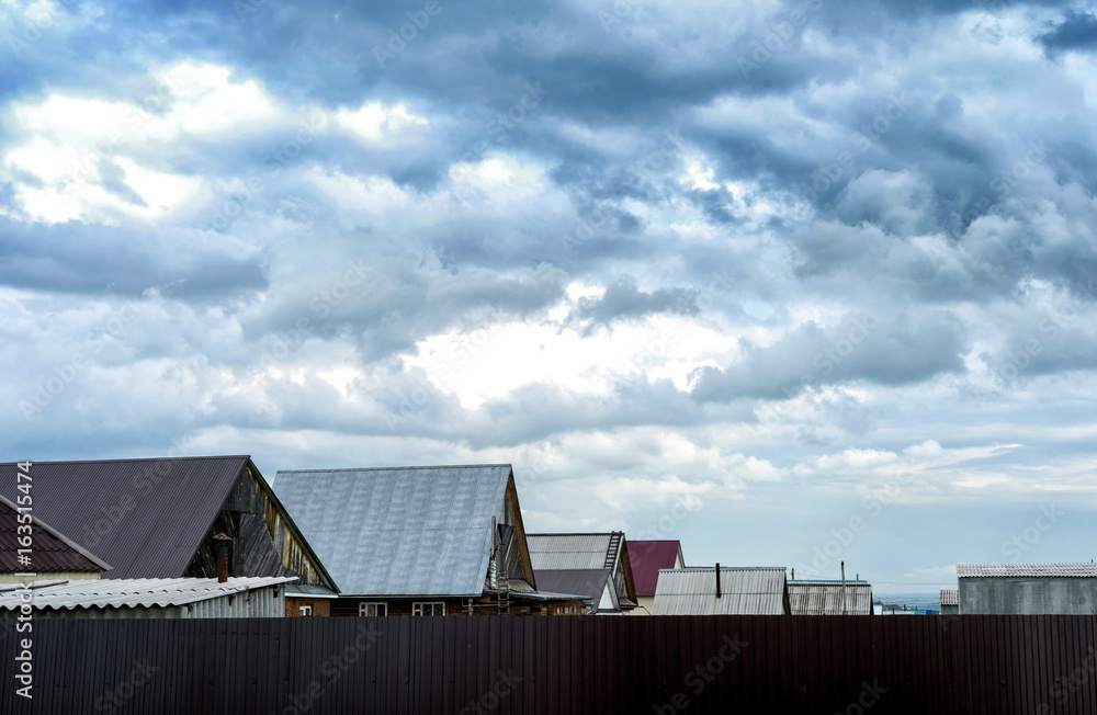 Village Rooftops and Grey Storm Clouds