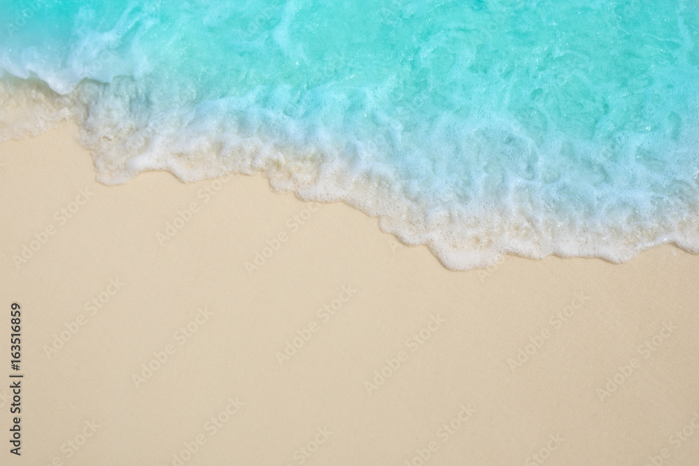 Soft waves of blue sea on the Maldives beach for the background.