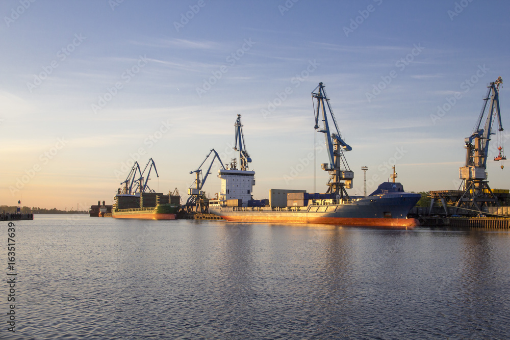 Riga industrial port with ships and cranes