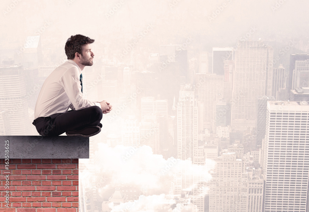 Office worker sitting on rooftop in city Office worker sitting on rooftop in city