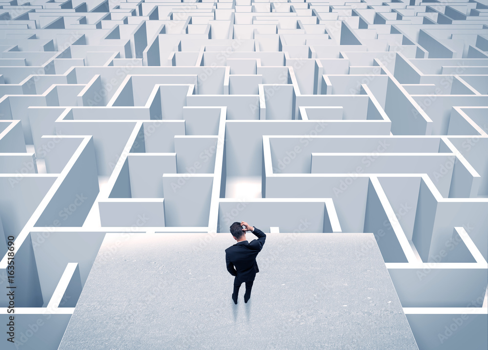Businessman staring at infinite maze Businessman staring at infinite maze