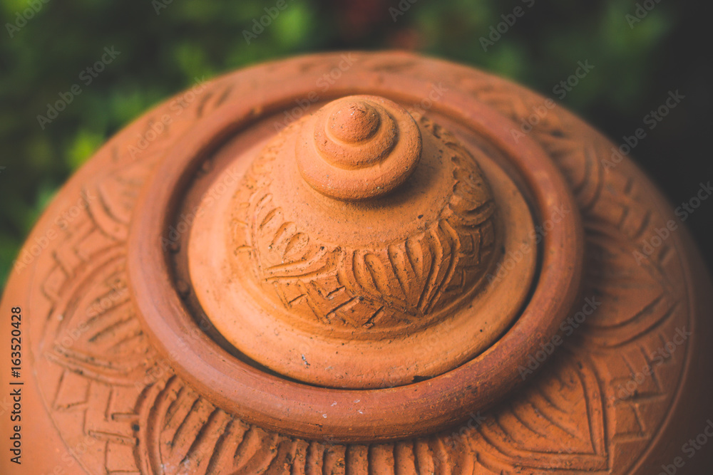 Closed up of orange baked clay pot,Clay pots for cooking outside a restaurant on background nature